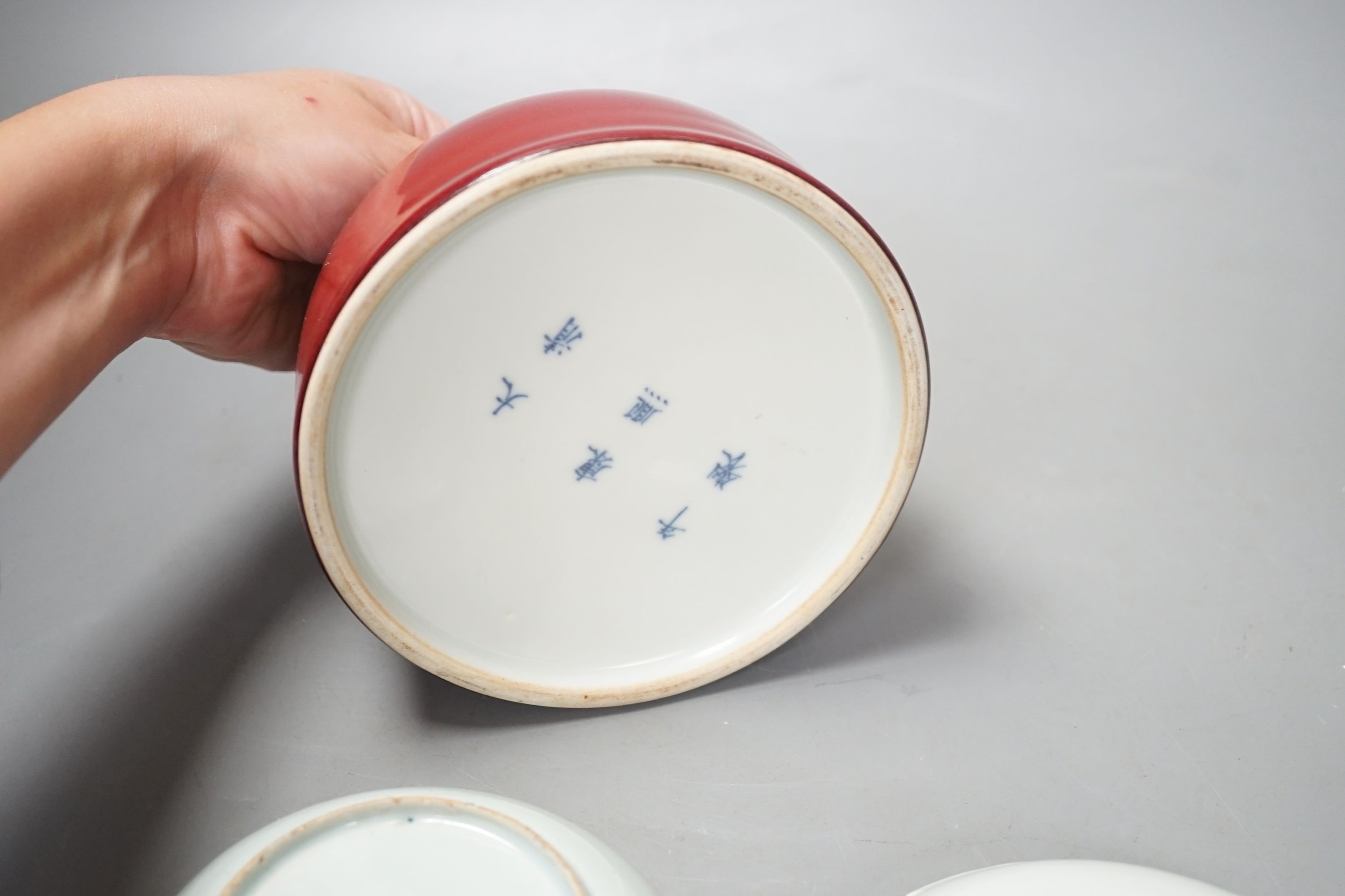 An 18th century Chinese Imari saucer, another blue and white saucer and sang de boeuf brush washer. Tallest 10cm